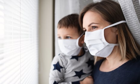 Mother and small son with face mask indoors at home