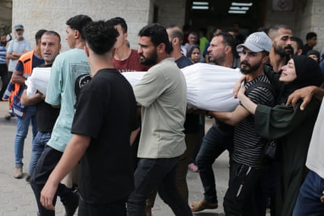 Palestinians carry the body of a relative killed in an Israeli airstrike.