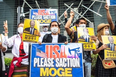 A group of Myanmar activists demonstrate with placards calling the US government to sanction Myanmar’s state-run Myanma Oil and Gas Enterprise ahead of Joe Biden’s visit to Japan on 22 May 2022.