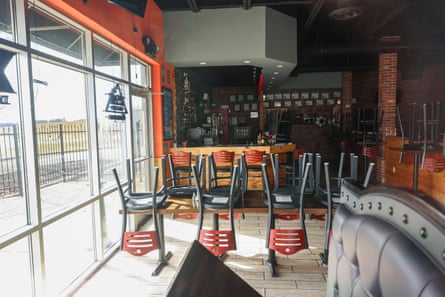 chairs stacked on top of a table in a dark restaurant