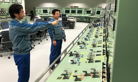 Tokyo Electric Power employees check instruments in a mock-up of the plant’s central control room. 