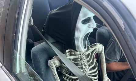 A fake skeleton in the passenger seat of a car