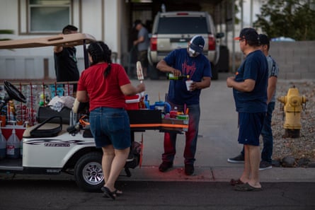 Alfonso, an elotero who has lived in Phoenix for seven years, wears a mask and serves customers in north Phoenix.