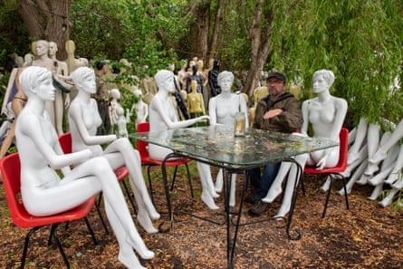 Mannakins seated in a wood around a table