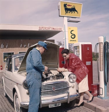 An Agip service station in 1959 with an attendant checking oil and water