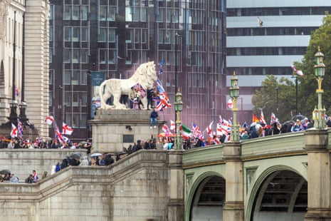 Crowds waving flags as they march during a ‘unite the kingdom’ rally in central London, on Saturday.