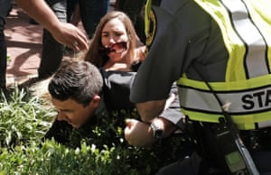 Kessler is helped by police after being tackled by a woman following his attempt to speak