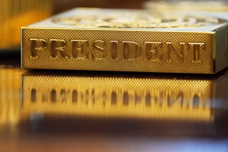 A gold item labelled ‘president’ on a desk