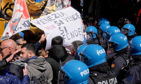 Citizens and activists confront police during a demonstration against Venice tax fee.