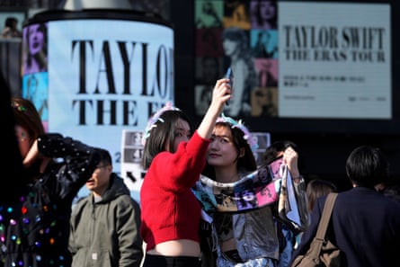 Fans pose for a selfie before Taylor Swift’s concert at the Tokyo Dome.