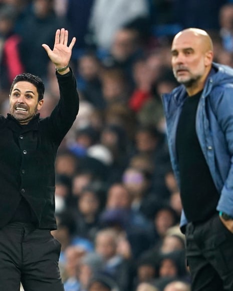 Mikel Arteta (left) gestures as he stands on the touchline next to Manchester City's Pep Guardiola