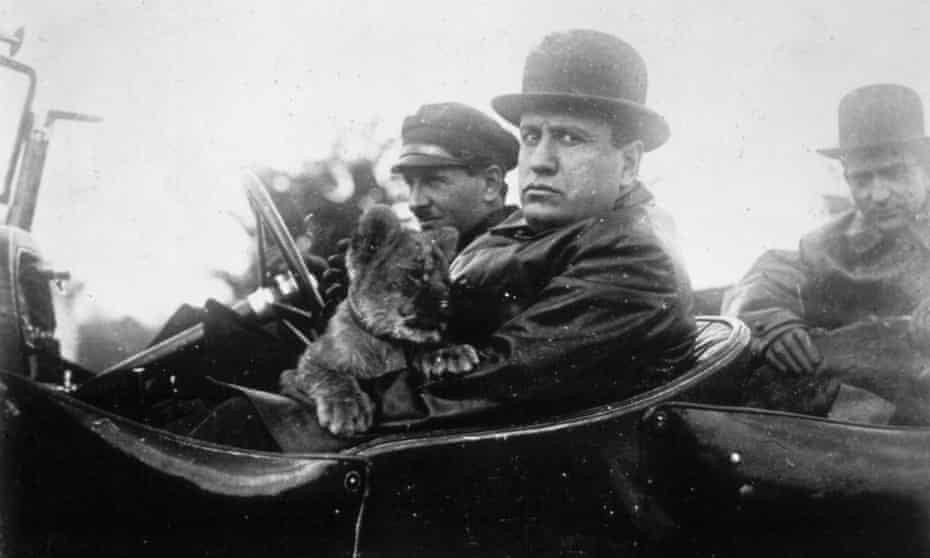Mussolini goes for a drive with his pet lion in 1924 