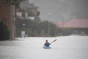 A kayaker paddles along McGrath Street in McGrath Hill near Windsor, north-west of Sydney