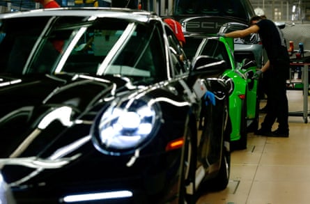 Porsche employees assemble sports cars at the factory in Stuttgart-Zuffenhausen.