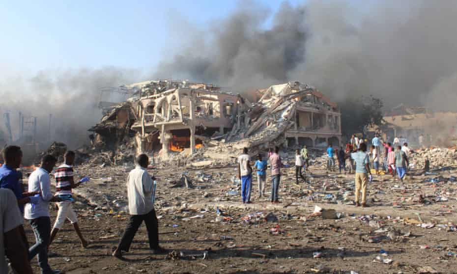 Citizens of Mogadishu survey the aftermath of a bombing by the Islamist group al-Shabaab on 14 October 2017. The 92 Somalis in the class action say they fear death and persecution at the hands of al-Shabaab.