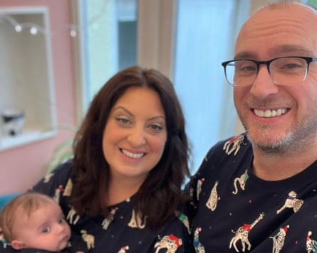 The couple holding their baby