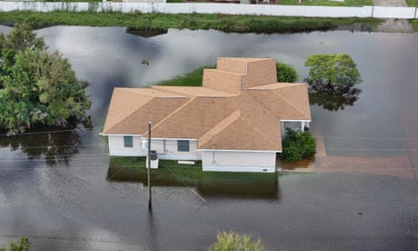 a house is surrounded by floodwater