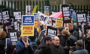 Protestors hold placards as they block the entrance to Woolwich Crown Court