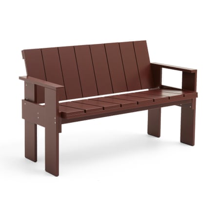 A dark brown bench made up of slatted wood.
