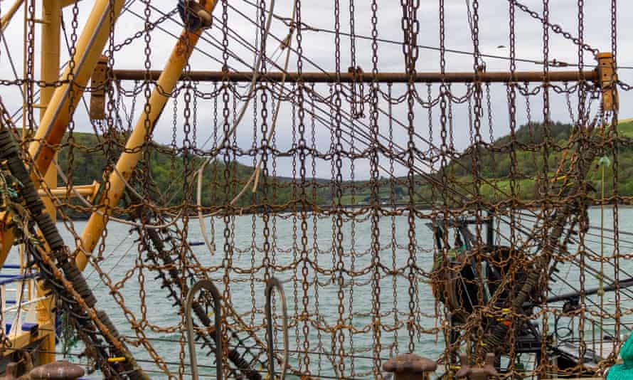 Beam trawler chains raised on booms