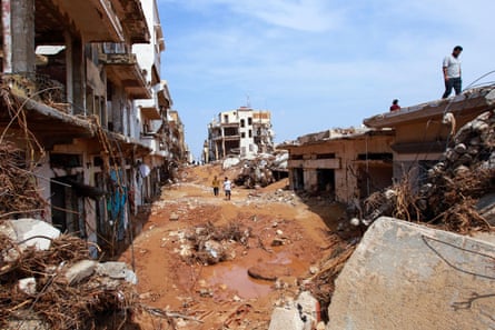 People check an area damaged by floods.
