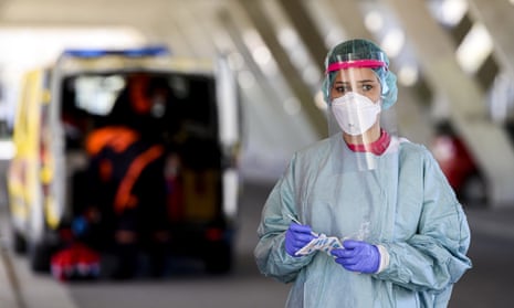 A Spanish health worker prepares to test people for Covid-19 at a drive-in facility in the northern city of Burgos