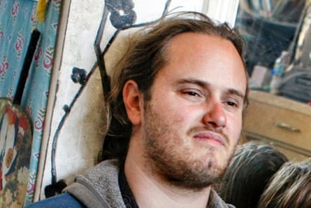 white man with mustache and beard looks forward