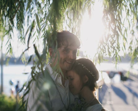 a happy couple embracing outside