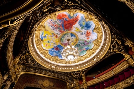 Chagall’s colourful painted dome ceiling surrounds a chandelier in the Paris Opera