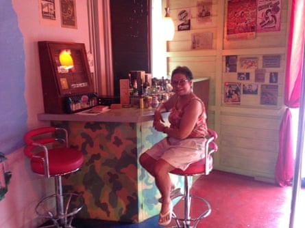 Chantawipa Apisuk, founder of Empower, sits at a museum exhibit recreating a 1970s bar where American soldiers would drink and have sex in Thailand