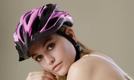 A woman in a bra and helmet looks at the camera with the slogan "Looks like shit. But saves my life' written over image.