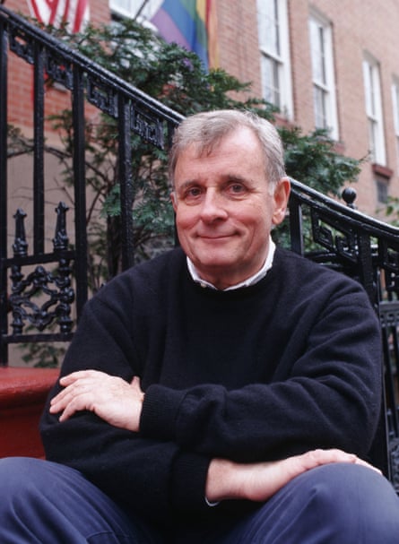Edmund White, smiling, sitting on steps in New York in 2000