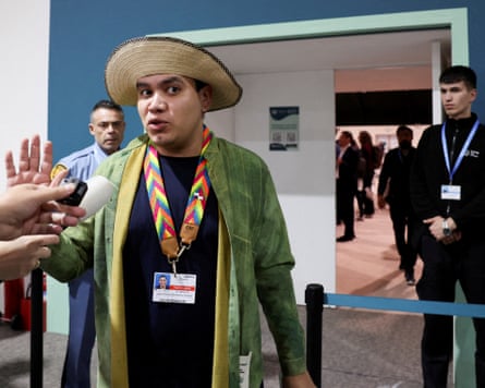 Juan Carlos Monterrey-Gómez speaking to reporters, with security guards behind him