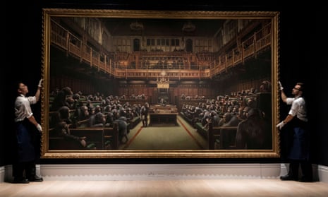 Sotheby’s staff hold Banksy’s Devolved Parliament.