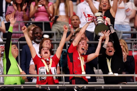 Mary Earps, Ella Toone, Millie Turner and Manchester United’s manager Marc Skinner lift the FA Cup in May 2024