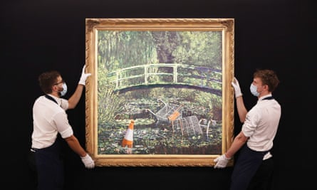 Technicians handling Banksy’s Show Me the Monet at Sotheby’s in central London.