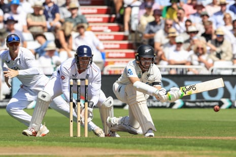 New Zealand's Tom Latham (R) plays a shot.