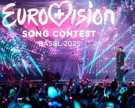 JJ from Austria stands on the stage with the trophy after winning the Grand Final of the 69th Eurovision song contest.