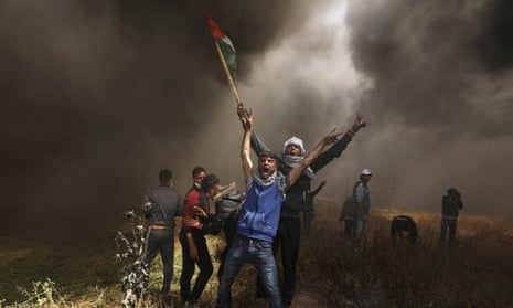 Palestinian demonstrators shout during clashes with Israeli troops at a protest at the Israel-Gaza border east of Gaza City, April 6, 2018