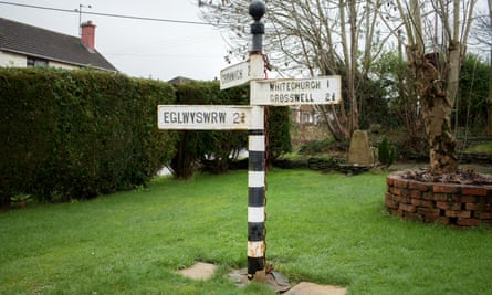 The old sign post in Pembrokeshire, as rain clouds envelop the village.
