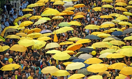Pro-democracy protesters holding yellow umbrellas outside the government headquarters in Hong Kong in 2015. 