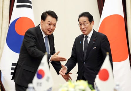 South Korean president Yoon Suk Yeol gestures to Japanese prime minister Fumio Kishida to take a seat, during their talks on the sidelines of the Nato Summit in July 2023.