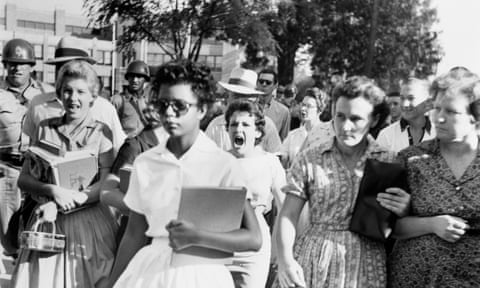 Elizabeth Eckford ignores the hostile screams and stares of fellow students on her first day of school. 