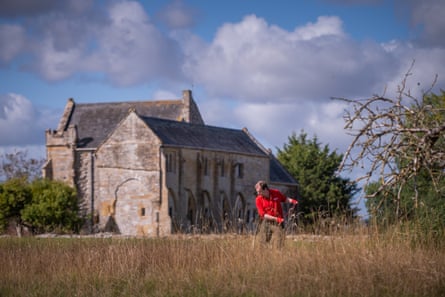 James Adams scything long grass at Muchelney Abbey