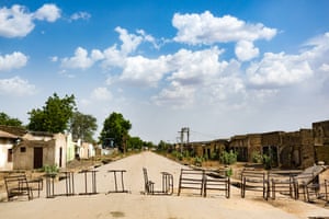 A row of old desks lies across the road on the outskirts of Banki town in north-east Nigeria