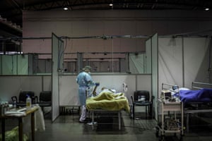 A healthcare worker attends to a patient at the Portimao arena sports pavilion which has been converted into a field hospital for Covid-19 patients.
