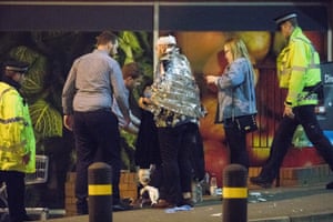 A man is kept warm by medics