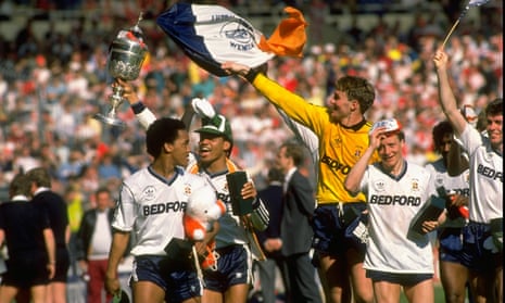 Luton players celebrate with the League Cup after an epic win against Arsenal.