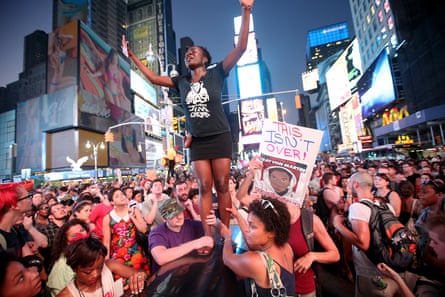 Trayvon Martin supporters rally in Times Square, New York, on July 14, 2013, after George Zimmerman was acquitted of all charges in the shooting to death of Martin