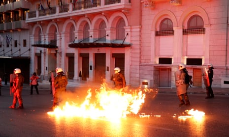 Greek police officers dodge petrol bomb during minor clashes in central Athens